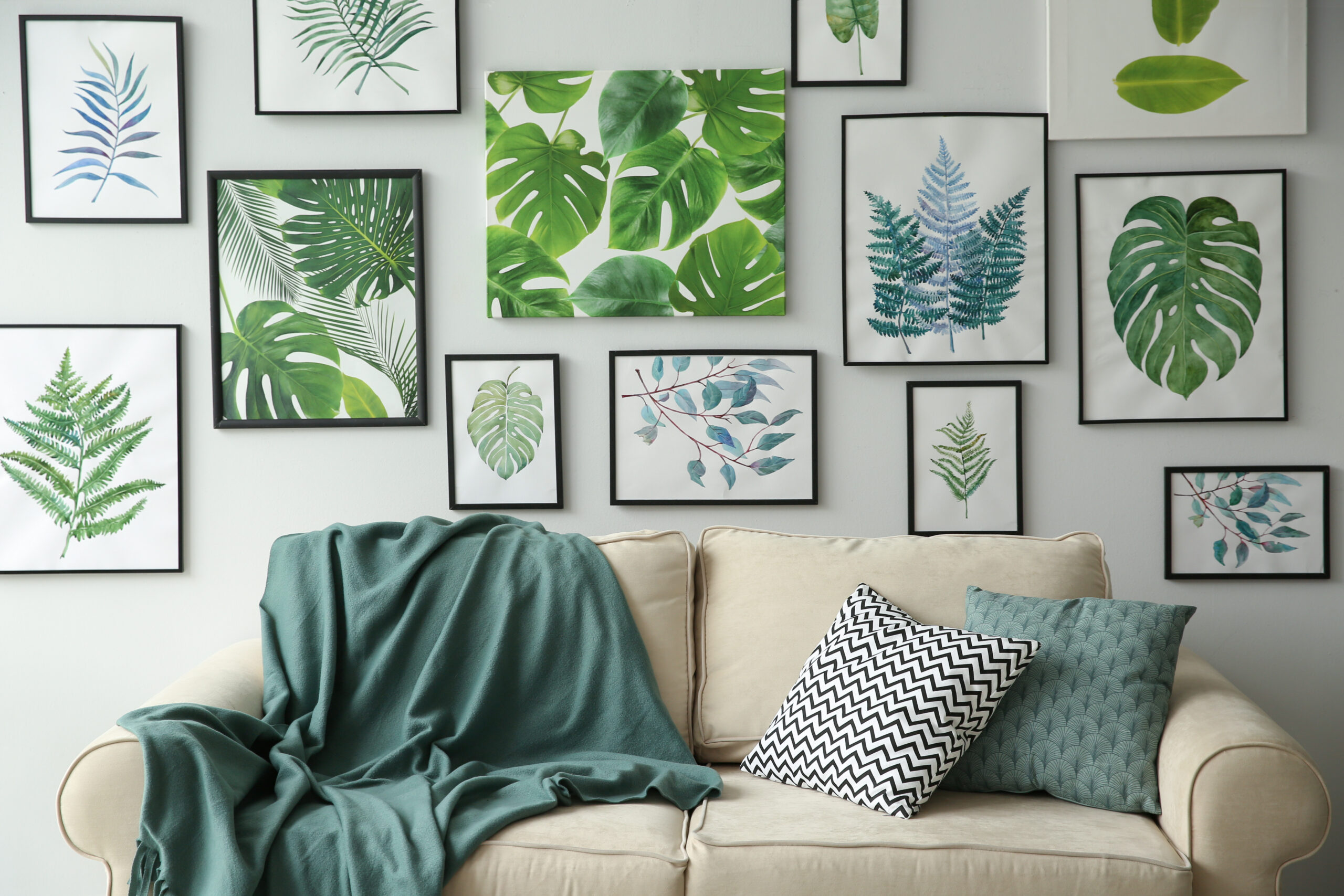 Gallery wall in living room with pictures of plants