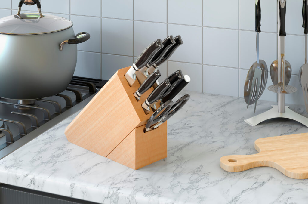 A set of knives stored in a wooden knife block on a kitchen countertop