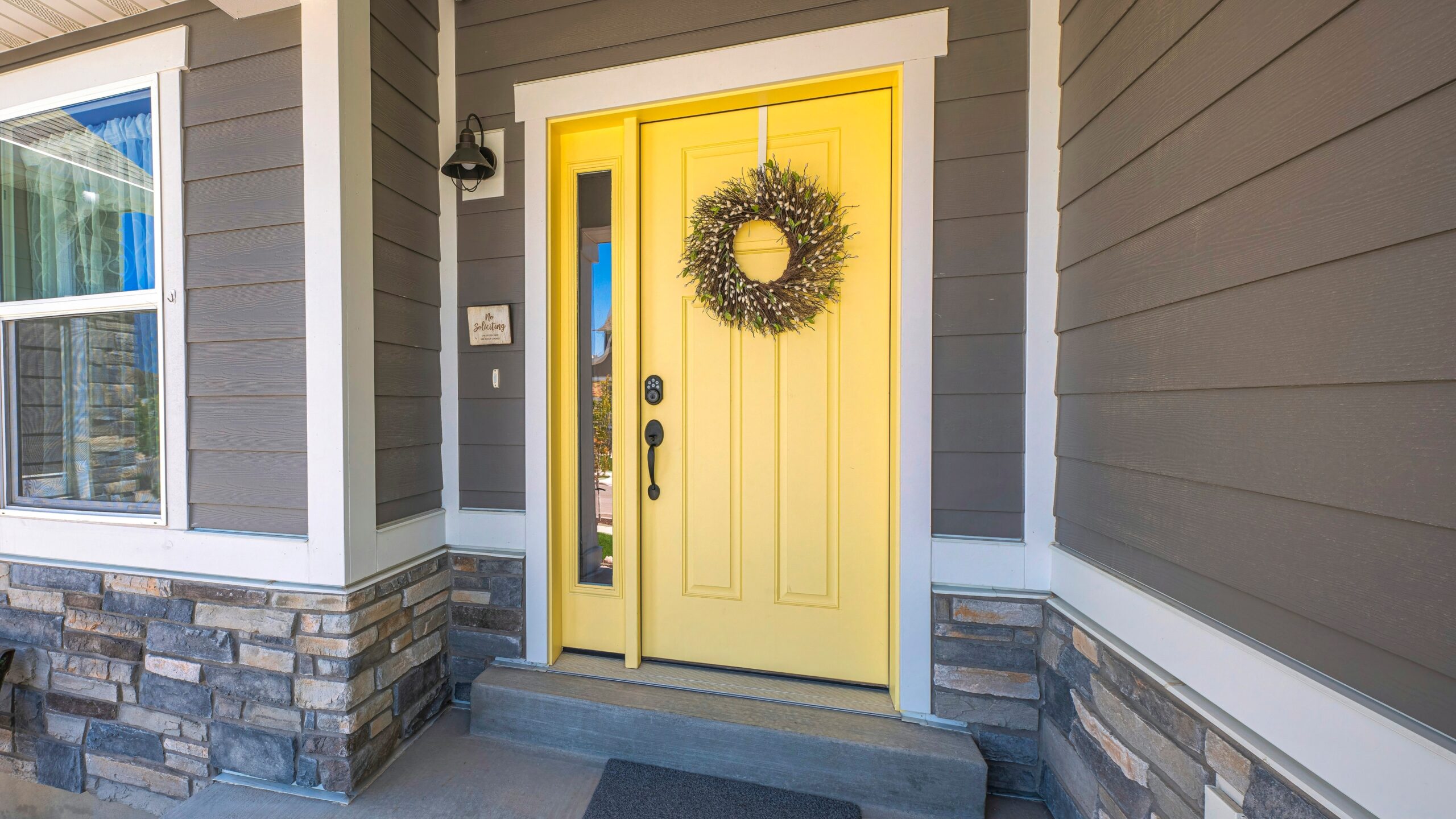 Yellow painted front door as one idea for DIY home projects under $100