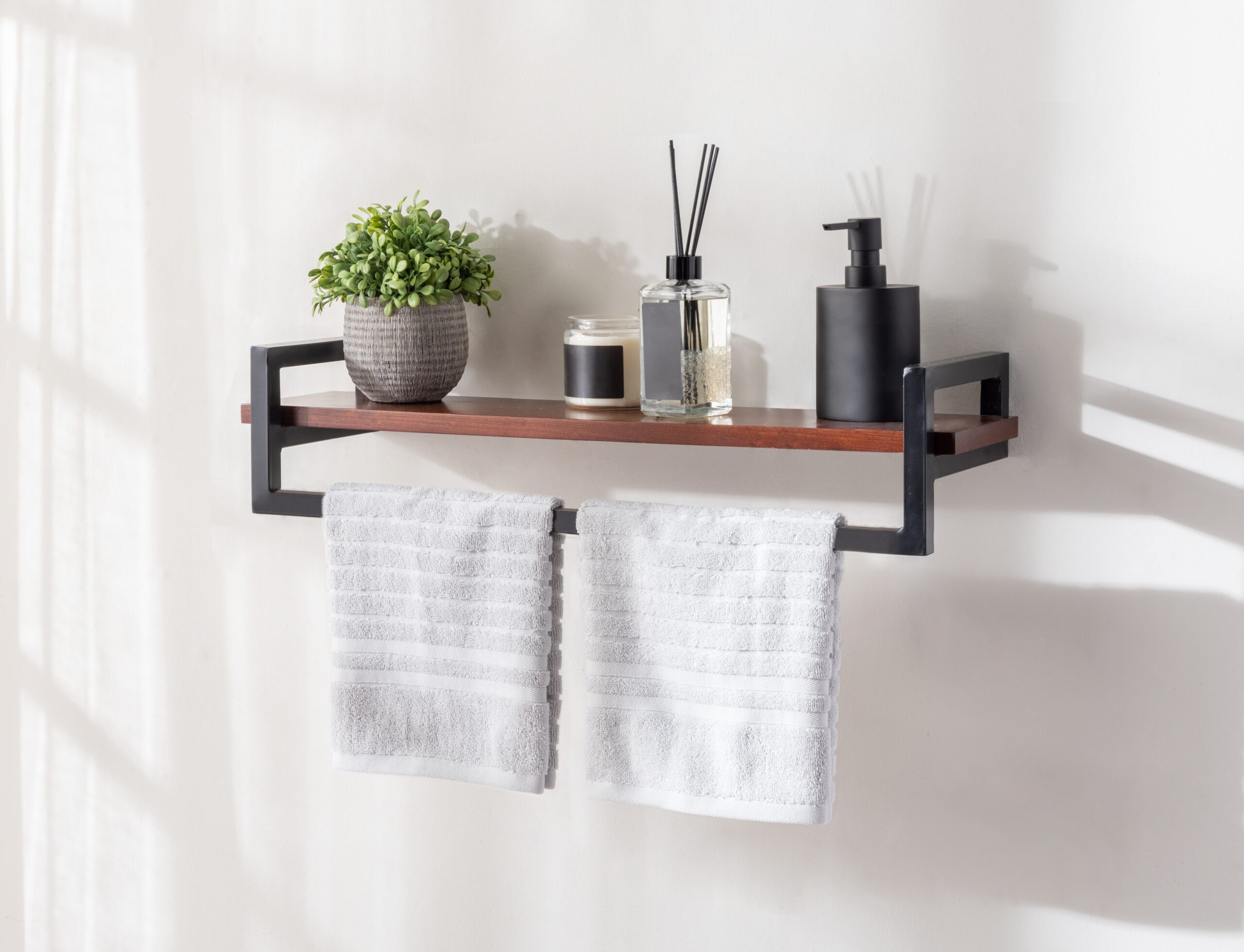 floating shelves in a bathroom with towels and diffusers