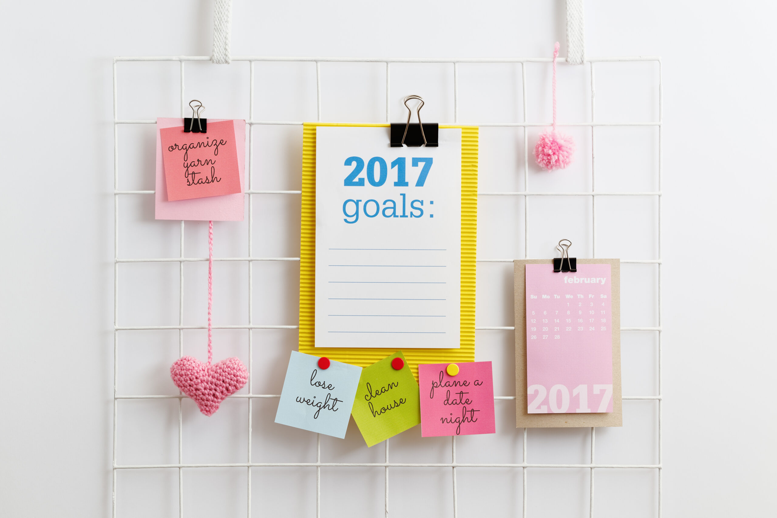 Notepads and sticky notes on a hanging board